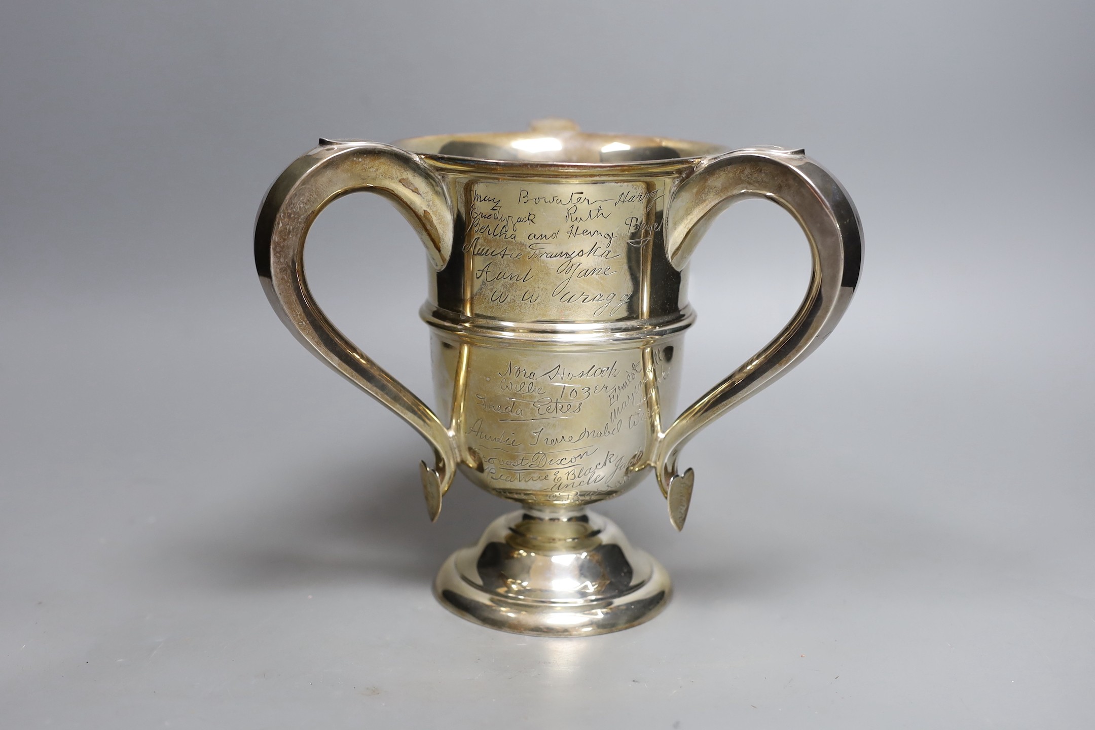 A George V silver tyg, with engraved signatures throughout, Walker & Hall, Sheffield, 1913, height 18.9cm, 23.2oz.